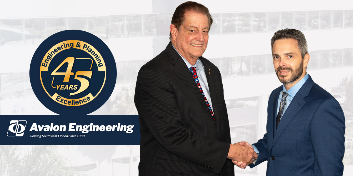 Founder Tom Giles shaking hands with new CEO Brendan Sloan after celebrating Avalon Engineering's 45th anniversary